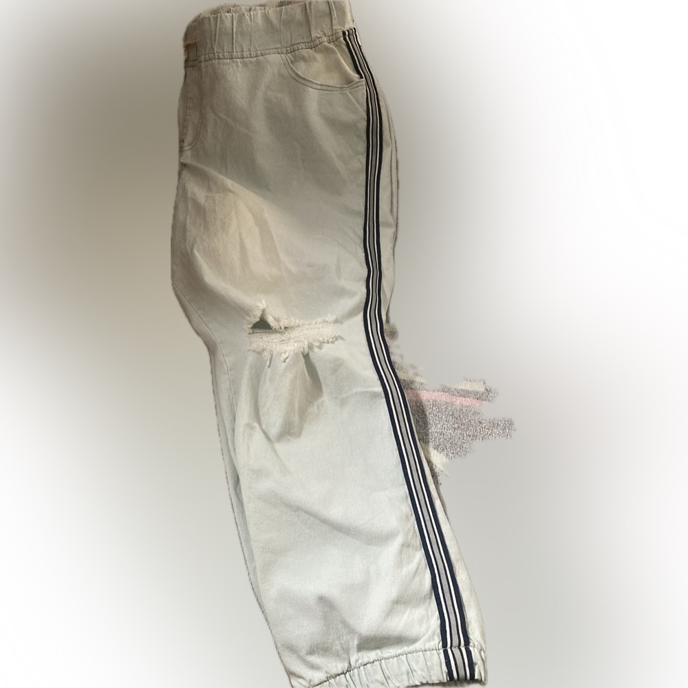 24W. Drawstring waist Ripped Capri Style Jean, with elastic bottoms.